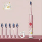 Brosse à dents électrique rose pour enfant avec un assortiment d'embouts